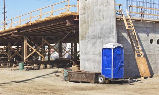 the convenience of on-site restrooms a job site lined with porta potties